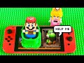 Lego Mario enters the Nintendo Switch to save Green Yoshi! Peach, Luigi & Toadette help! #legomario