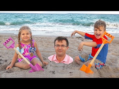 Diana and Roma play with Dad on the Beach
