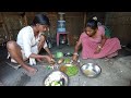 BANGALI TRIBE GIRL COOKING IN TRADITIONAL STYLE OF EATING FOOD - RURAL LIFE IN ASSAM