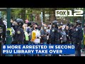 Police arrest 8 more after protesters rip down barricades, break into PSU library again