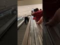 Man Runs up Downward Traveling Escalator as Strangers Cheer Him on