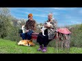 Happy old age of an elderly couple with their animal friends in a mountain village