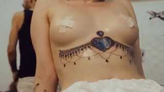 Under breast tattoo by Ilya Agapov