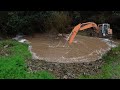 Digger clears blocked culvert to save road during 100 year Nelson Flood