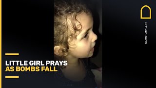 Little girl prays as bombs fall