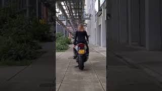 Blonde girl dancing on motorbike