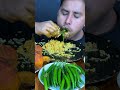 eating spicy green chili with big bite shorts