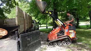 Loading up Big Tex Dump trailer with Massive logs w Ditch Witch sk800