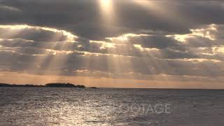 Timelapse Shot Of Light Rays Streaming Through Clouds Over Ocean