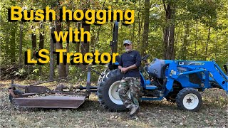 LS tractor running an ancient bush hog while mowing a pond dam!