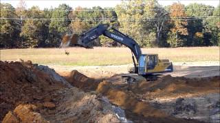 Excavator and Dozer Building Pond Dam