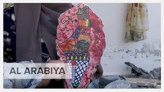 Gaza artist paints on the remains of her demolished house