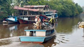 Morning activities of transmigration residents crossing the Kapuas River using a klotok boat