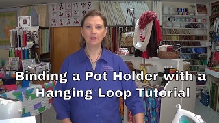 Binding a pot holder with hanging loop.