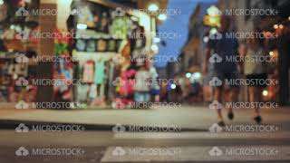 Shopping street in the tourist resort town of Catalonia Calella with tourists. Blurred view.