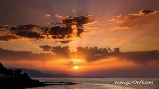 Time lapse sunbeams at sunset over the coast of Crete