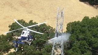 How does PG&E keep transmission lines clean and functional?