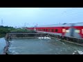 full speed train passing through dangerously overflowing broken canal