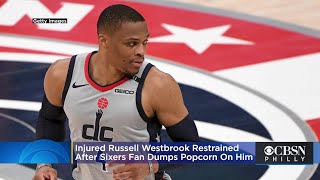 Injured Russell Westbrook Has To Be Restrained After Sixers Fan Dumps Popcorn On Him