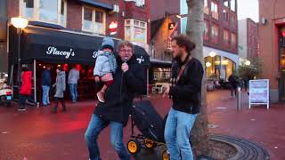 A Father Join this street Busker and singing some reggae stuff with carrying baby girl in his arms