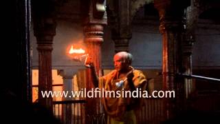 Hindu priest performs aarti at a temple in Varanasi