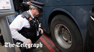 Protesters slash bus tyres to stop removal of migrants from London hotel