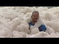 raw sea foam blankets australian beach town