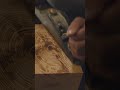 Using a hand plane to smooth out a timber frame rafter