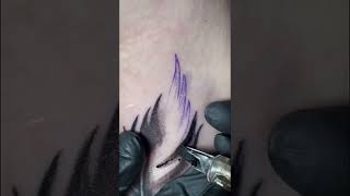 Feather with flowers tattoo