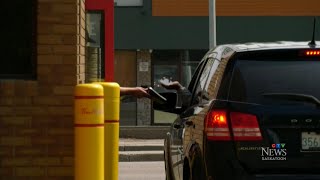 Driver in Sask. ticketed by police for using food-ordering app on phone in drive-thru line