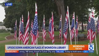 Upside-down American flags flown outside Monrovia Public Library