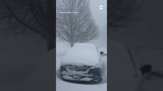 Man opens garage door to reveal heavy snowfall in New York