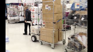 Towing multiple retail stock trolleys in store using electric tug | Battery powered tug