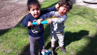 twins fighting over a scooter