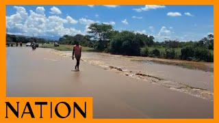 People cross flooded section of Nakuru-Ravine highway after River Rongai burst its banks