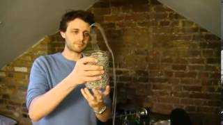 Presenter shows chain of beads defying gravity