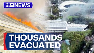Thousands evacuated from Sydney Olympic Park after solar panel fire | 9 News Australia