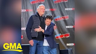 Michael J. Fox and Christopher Lloyd share a hug at New York Comic Con l GMA