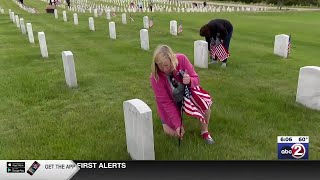 Hundreds place flags at Central Wisconsin Veterans Memorial Cemetery for Memorial Day