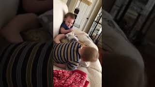 Adorable twins fighting over blanket