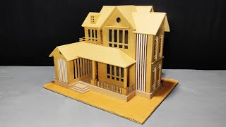 Double storey cardboard house with porch.