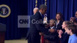 OBAMA SIGNING EXECUTIVE ORDER- HUGS KIDS