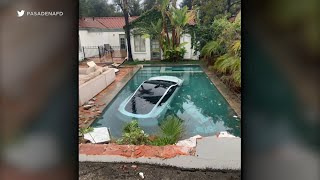 Tesla driver slams through wall, lands in pool; 3 people rescued