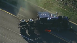 Semi-truck overturns on I-57, catches fire