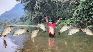 The boy cast a net in the stream. He caught a large school of fish and enjoyed grilled fish.