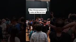 Man in Wig Throws Cake at Glass Protecting Mona Lisa