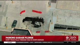 Truck Plunges Through Parking Garage