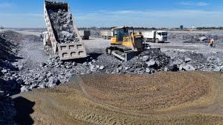 Processing Filling Stone Into Deeply Lake,Technique Bulldozer Push Stone and Truck Unloading Stone