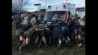 Rugby players form 'scrum' to free ambulance stuck in mud