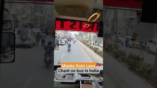 Monks and buddhist from Laos make a group chanting on the bus in India